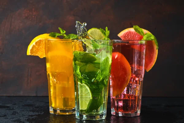 Three Classic Cocktail Glasses Stone Black Table Splashing Water Dark — Stock Photo, Image