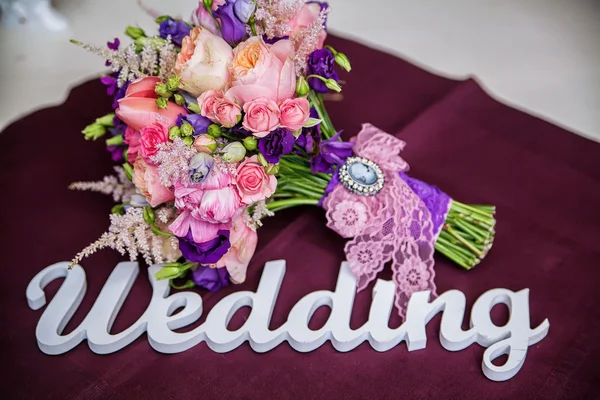 The word Wedding and bridal bouquet