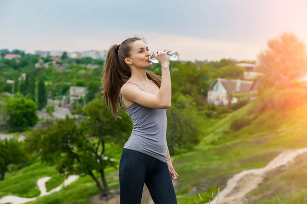 Chica de fitness sedienta sosteniendo botella de agua — Foto de Stock