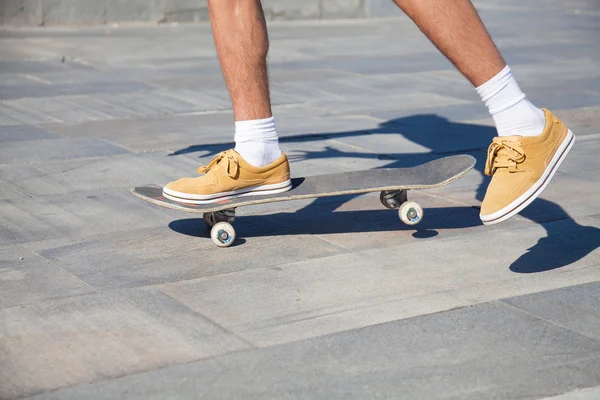 Skateboarders feet while skating — стоковое фото