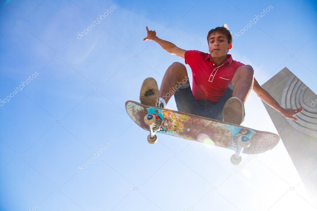 male skateboarder jumping on skateboard