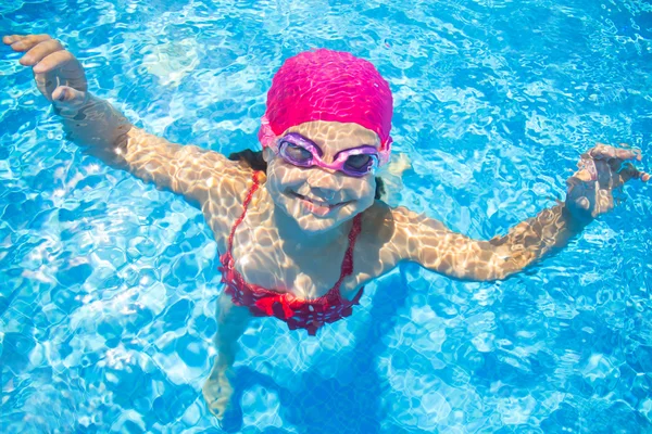 Маленька дівчинка плаває в басейні під водою — стокове фото