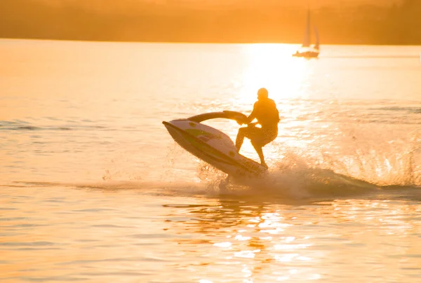 Silhouette of strong man on jet ski — Stock Photo, Image