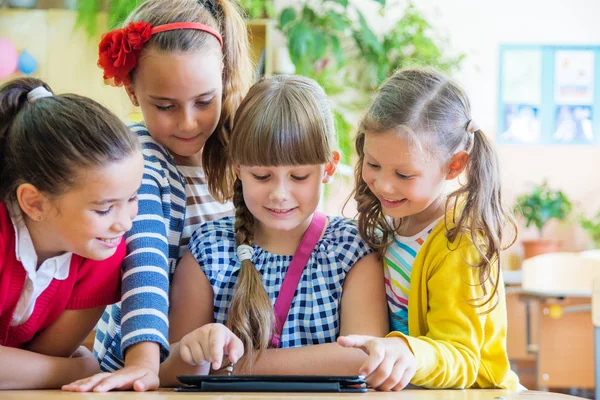 Schoolgirls together using digital tablet — Stock Photo, Image