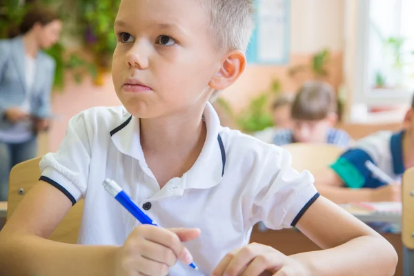 Little schoolboy writing a lesson — Stock Photo, Image