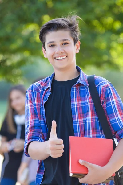 Young boy student holding books — ストック写真