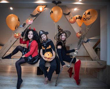 Çocuklar cadılar bayramında tavan arasında oynuyorlar.