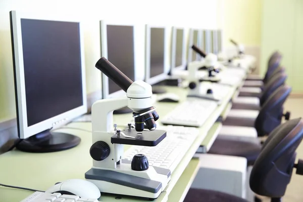 computer lab with monitors and educational microscopes on the table