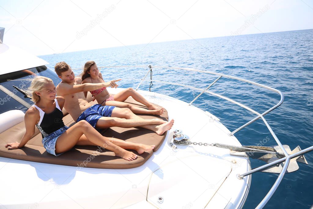 group of young people enjoying a yacht holiday in the sea