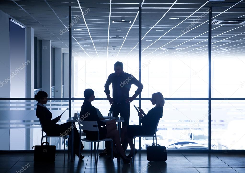 Silhouettes of businesspeople in business centre