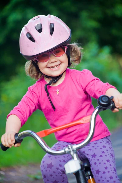 Little girl in helmet on bicycle — Stock Photo, Image