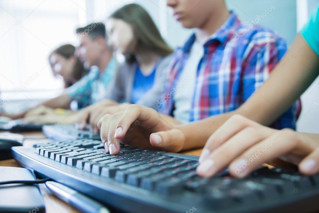 teens at computers in classroom