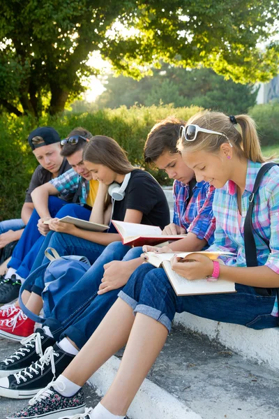 Group of young students with books