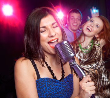 partide mikrofona şarkı söyleyen kız