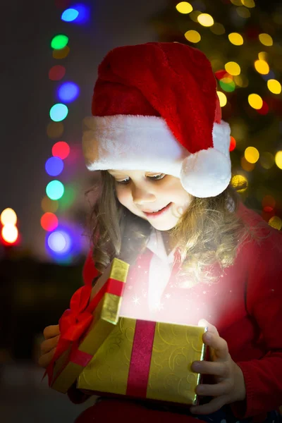 Little girl opening Christmas gift Stock Image