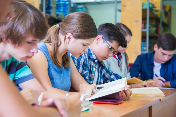 Alunos aprendendo na biblioteca — Fotografia de Stock