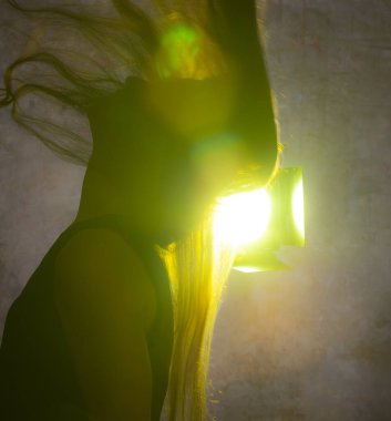 Genç ve güzel bir kadının altın ışığına karşı portre