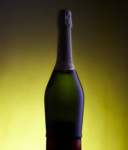 View of Sparkling wine bottle on yellow background