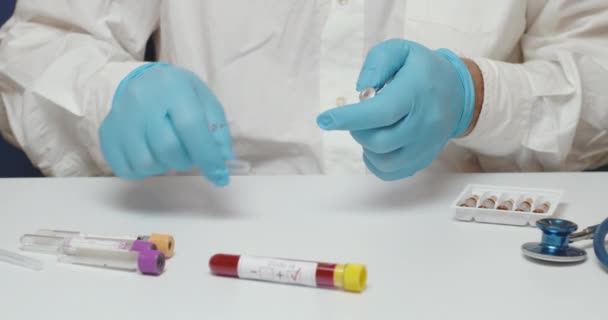 Close Doctor Hands Wearing Blue Gloves Using Syringe Coronavirus Vaccine — Stock Video