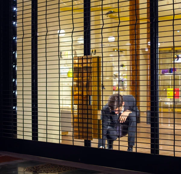 Salesman close shop shutter — Stock Photo, Image