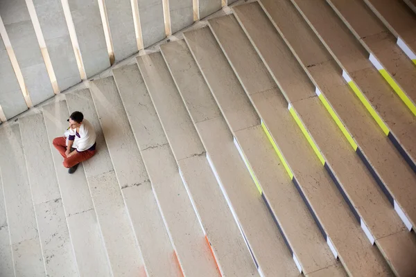 Girl sitting on staircase — Stock Photo, Image