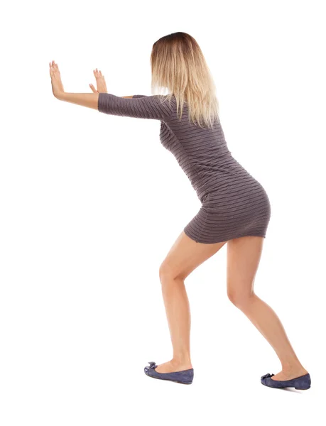 Woman pushes wall — Stock Photo, Image