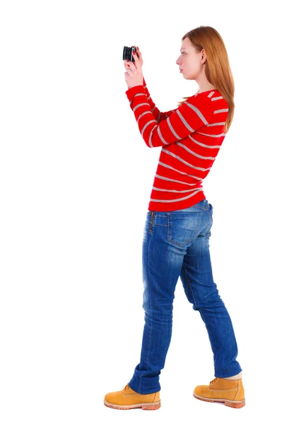 Back view of standing young beautiful  woman  and using a mobile — Stock Photo, Image