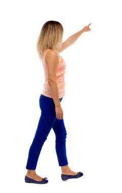 back view of pointing walking  woman