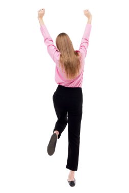 Back view of  business woman.  Raised his fist up in victory sig