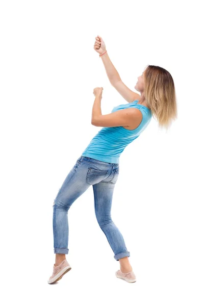 Back view of standing girl pulling a rope from the top or cling — Stock Photo, Image