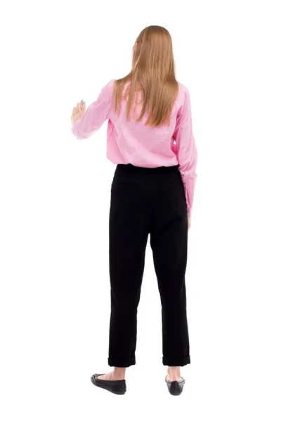 Back view of young business woman presses down on something. — Foto de Stock