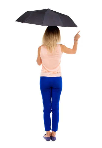 Pointing  woman  under an umbrella — Zdjęcie stockowe