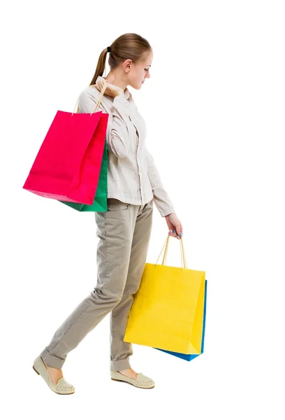 Visão traseira da mulher com sacos de compras  . — Fotografia de Stock
