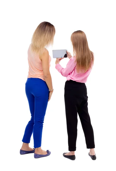 Back view of two young woman look at the smart phone. — Stock fotografie