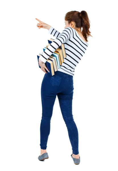 Muchacha con una pila de libros señala con el dedo. — Foto de Stock
