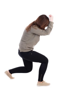 Arkadan ayakta genç güzel kadın kot pantolon görünüşü