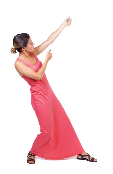 Back view of standing girl pulling a rope from the top or cling — Stock Photo, Image