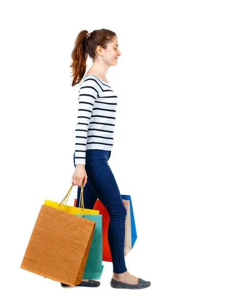 Side view of going  woman  with shopping bags . — Stockfoto