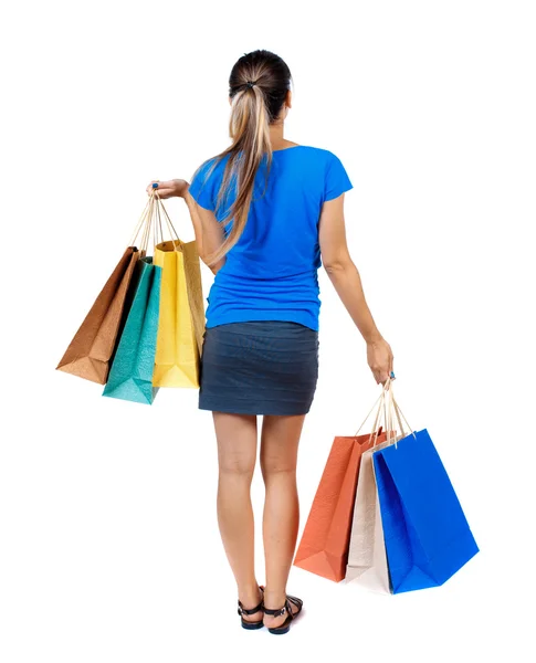 Vista trasera de la mujer con bolsas de compras — Foto de Stock