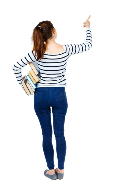 Menina com uma pilha de livros aponta o dedo. — Fotografia de Stock