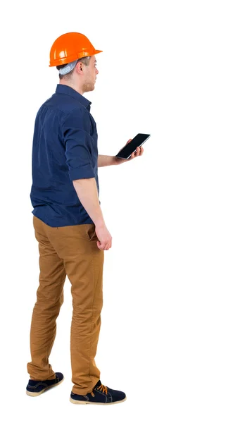 Backview of business man in construction helmet stands and enjoy — Stock Photo, Image