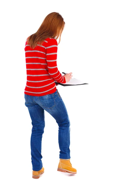 Back view of  stands woman takes notes in a notebook — Stock Photo, Image