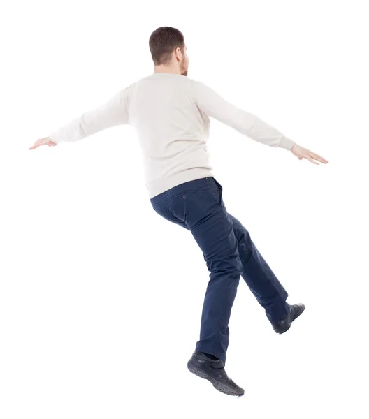 Balancing young man. or dodge the falling . — Stockfoto