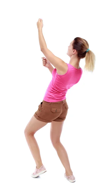 Back view of standing girl pulling a rope from the top or cling — Stock Photo, Image