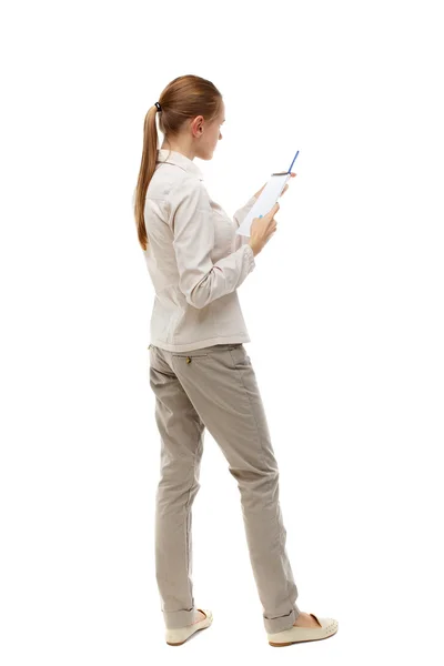 Back view of  stands woman takes notes in a notebook — Stock Photo, Image