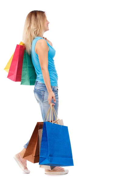 Side view of going  woman  with shopping bags . — Stockfoto
