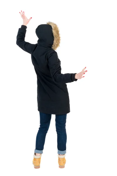 Back view woman in winter jacket  Balances waving his arms. — Stock Photo, Image