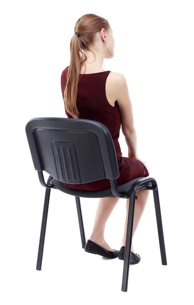 Back view of young beautiful  woman sitting on chair. — Stok Foto
