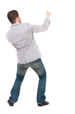 Arkadan ayakta adam bir ip üstten çekerek görünüşü veya t sarılmak