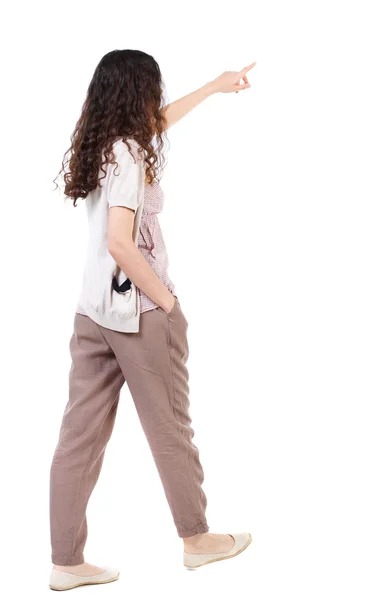 Back view of pointing walking  woman — Stock Photo, Image